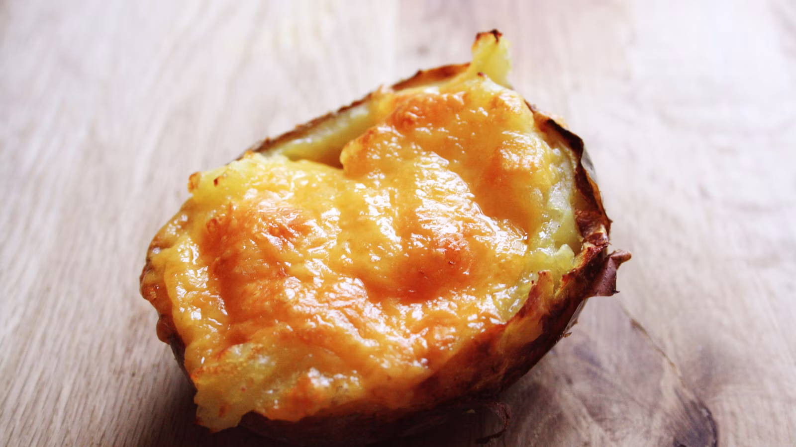 Baked potato served on a wooden table