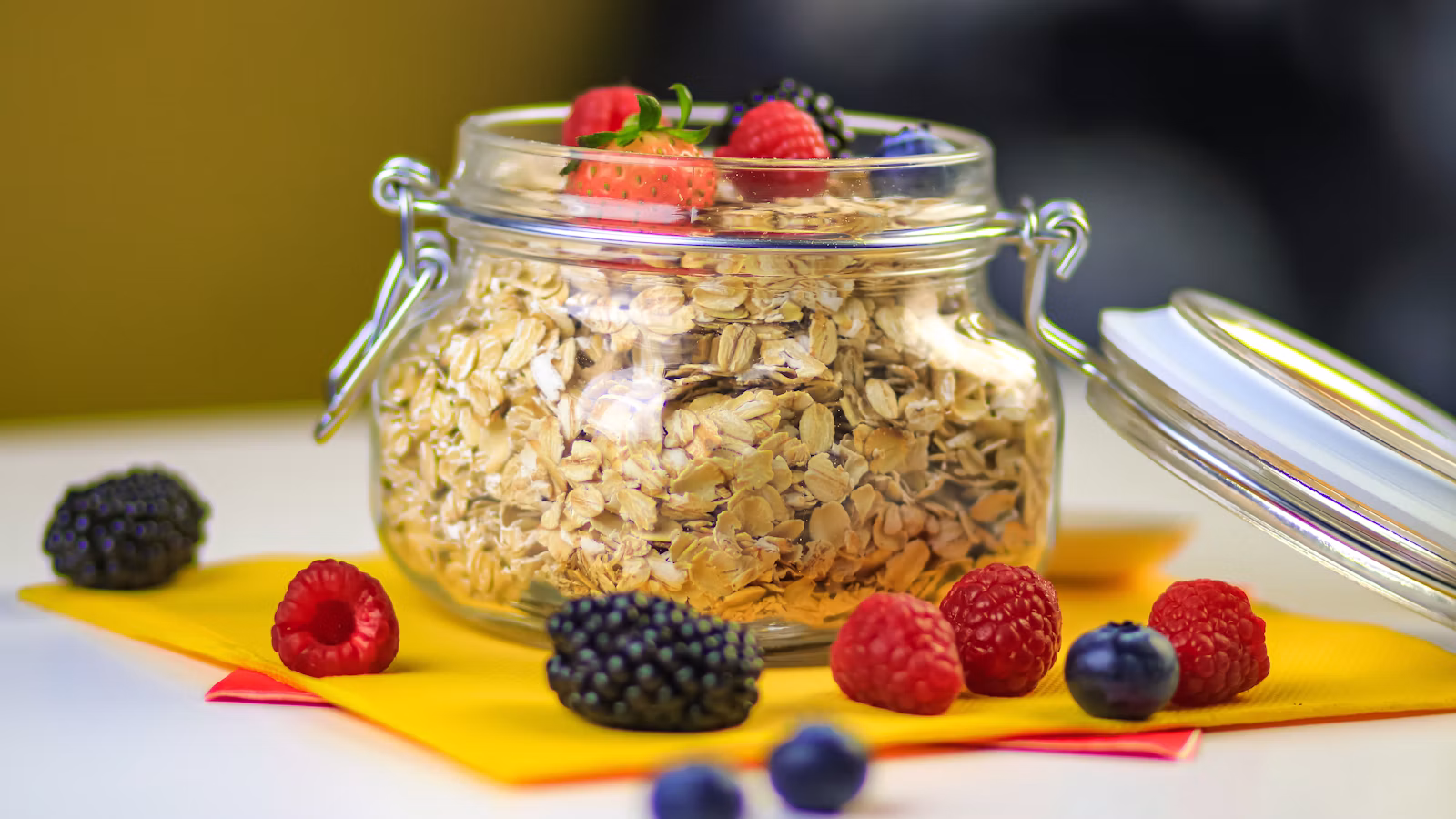 Creamy oats topped with fresh berries in a glass jar