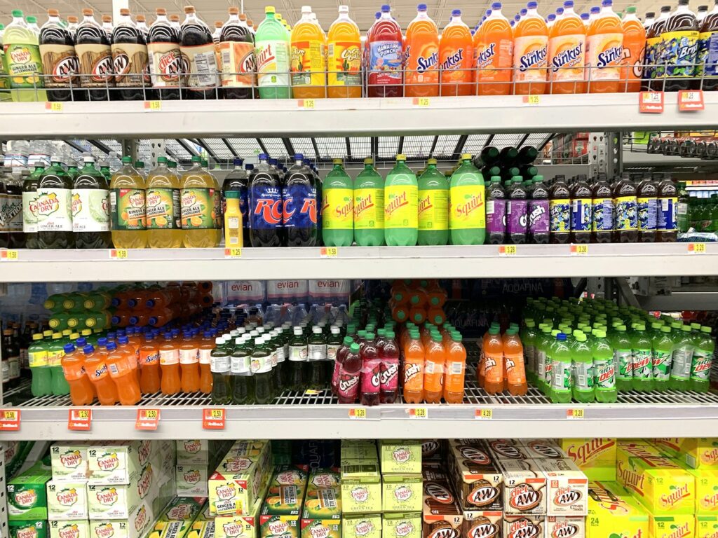 Assorted bottled drinks arranged on a store shelf