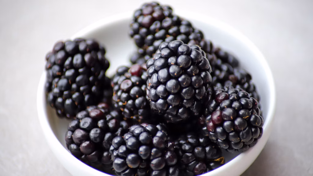 Dark cane berries piled in a small bowl