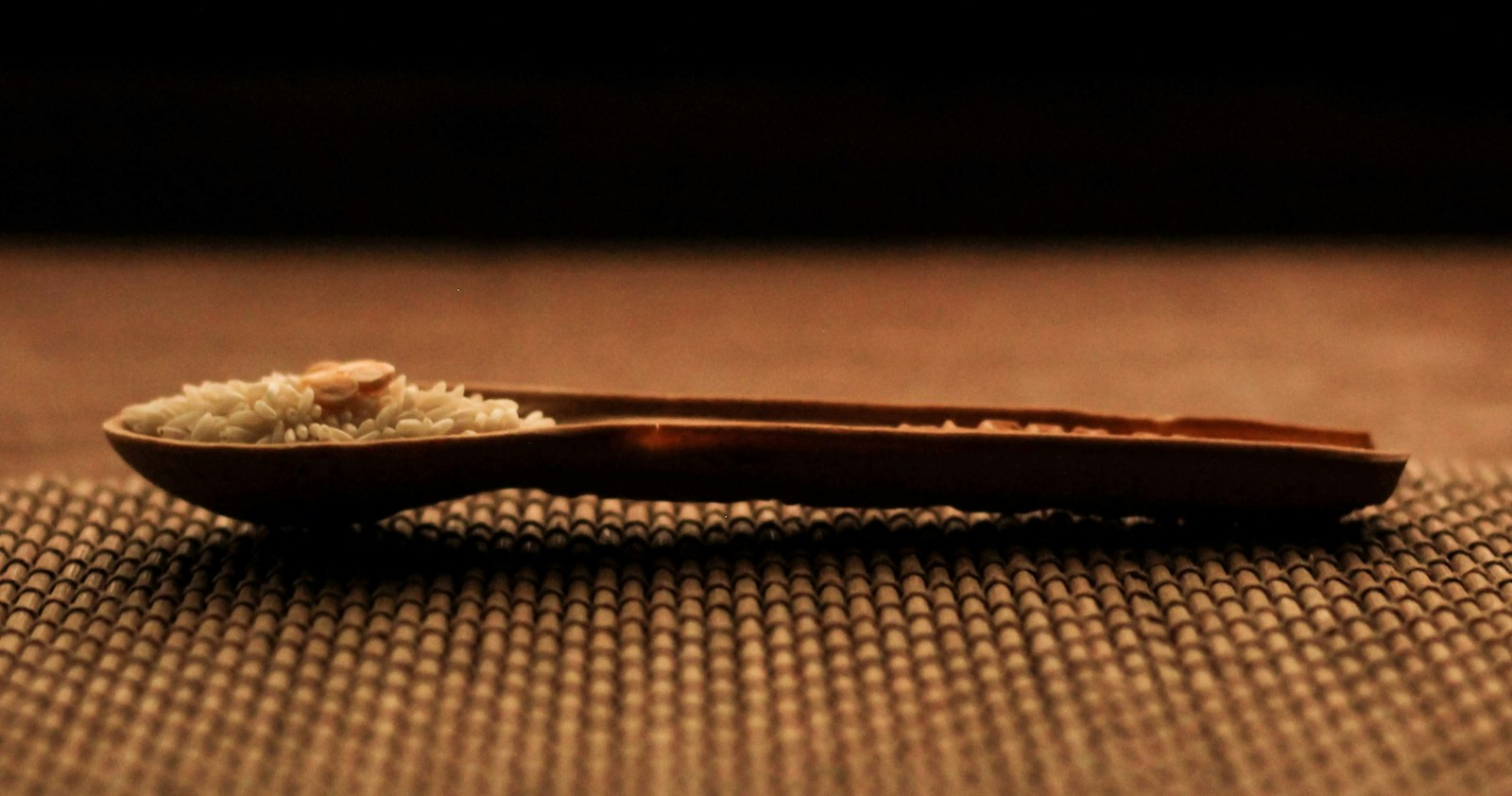 Wooden spoon holding coarse brown sugar