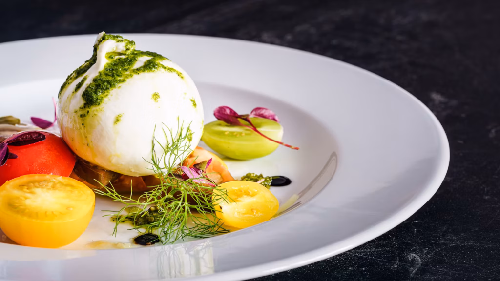 Burrata cheese served with tomatoes and herbs
