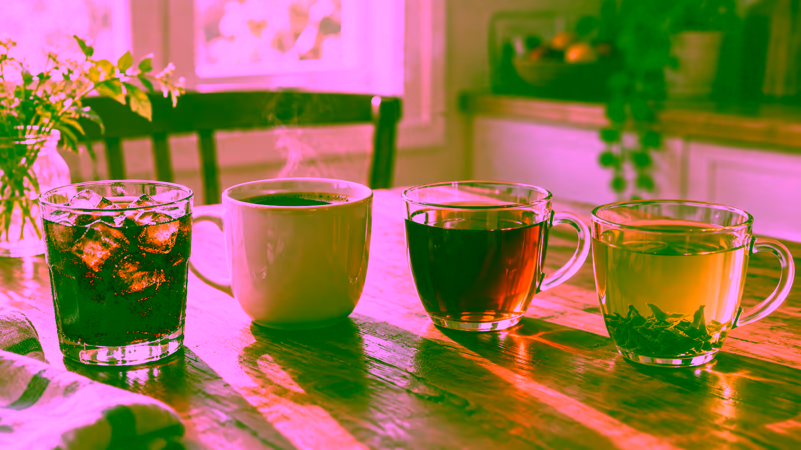 A glass of cola beside cups of coffee, black tea, and green tea for a caffeine comparison