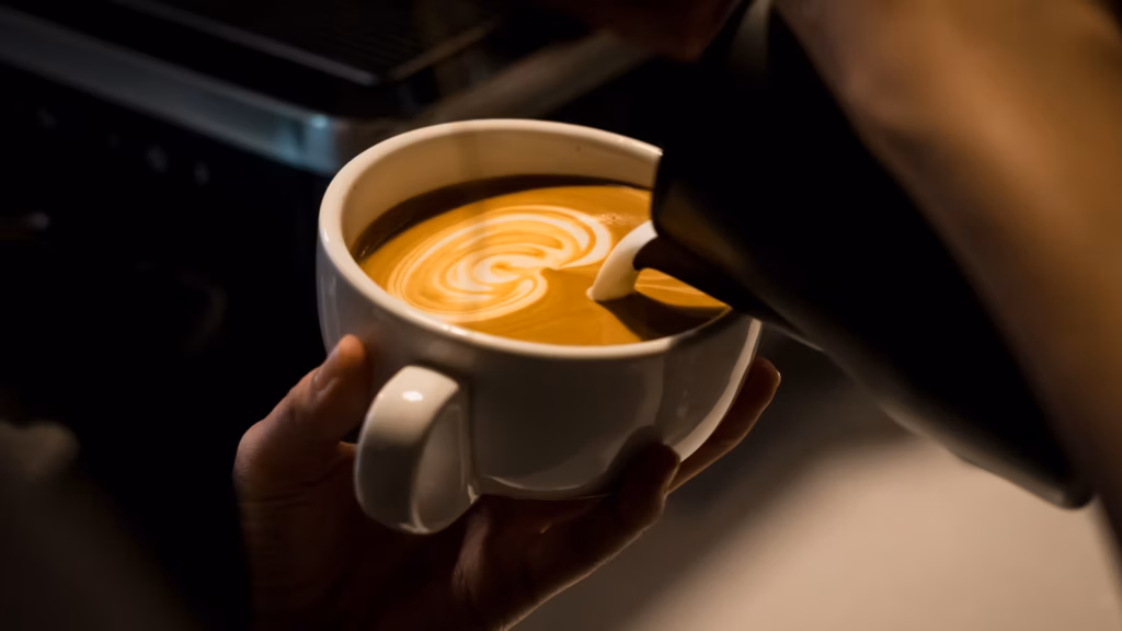 Foamy milk coffee in a white ceramic cup