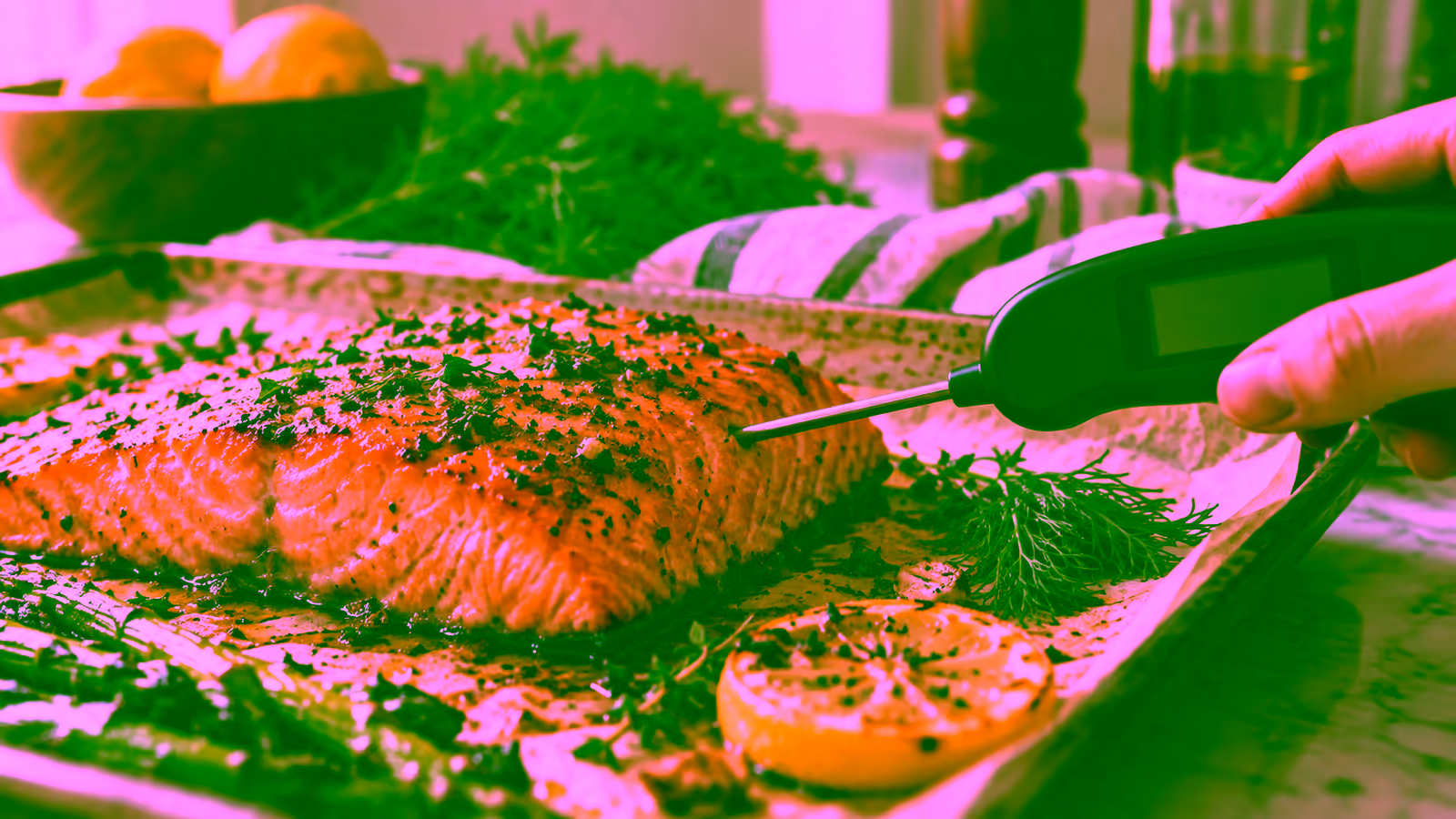 An instant-read thermometer inserted sideways into the thickest part of a salmon fillet