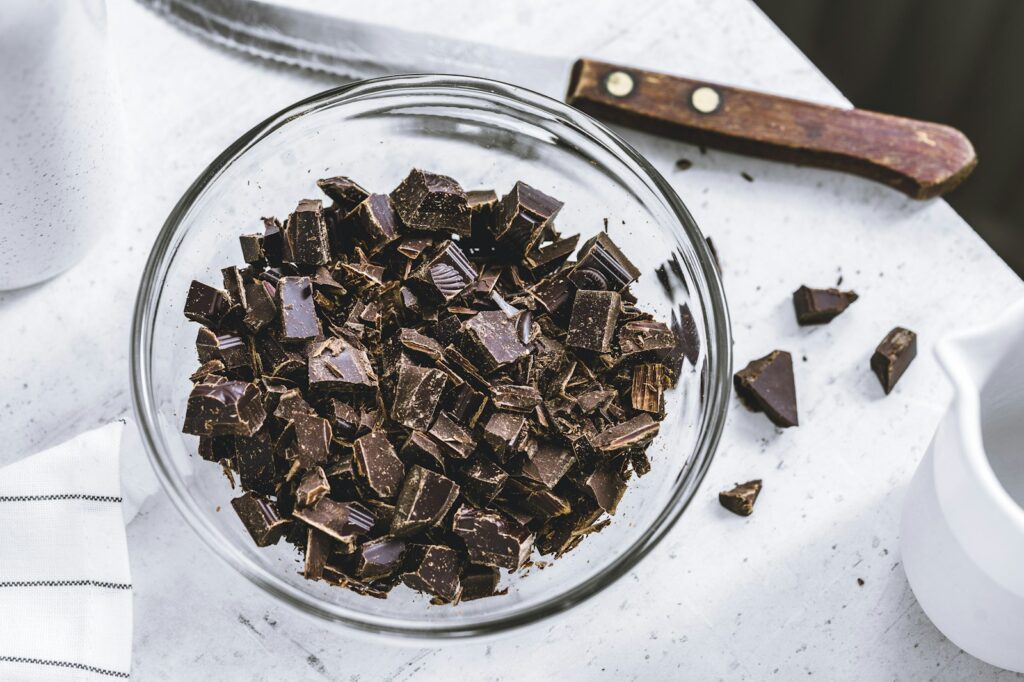 Chopped dark chocolate pieces on a board