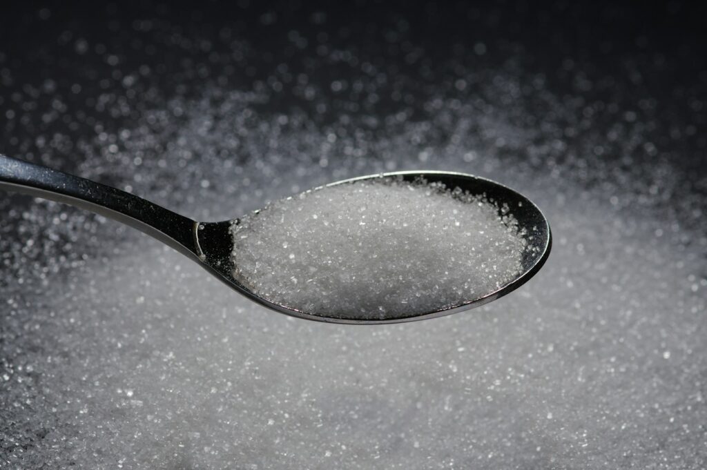 Spoonful of coarse golden-brown sugar crystals