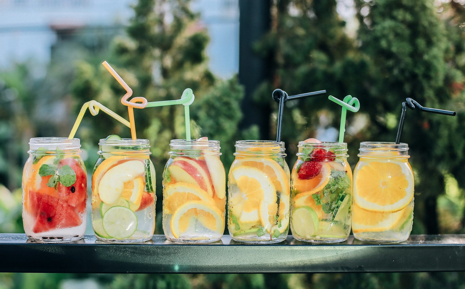 Colorful fruit-flavored drinks in glass bottles