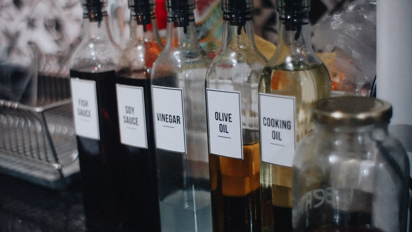 Savory condiment bottles arranged on a kitchen counter