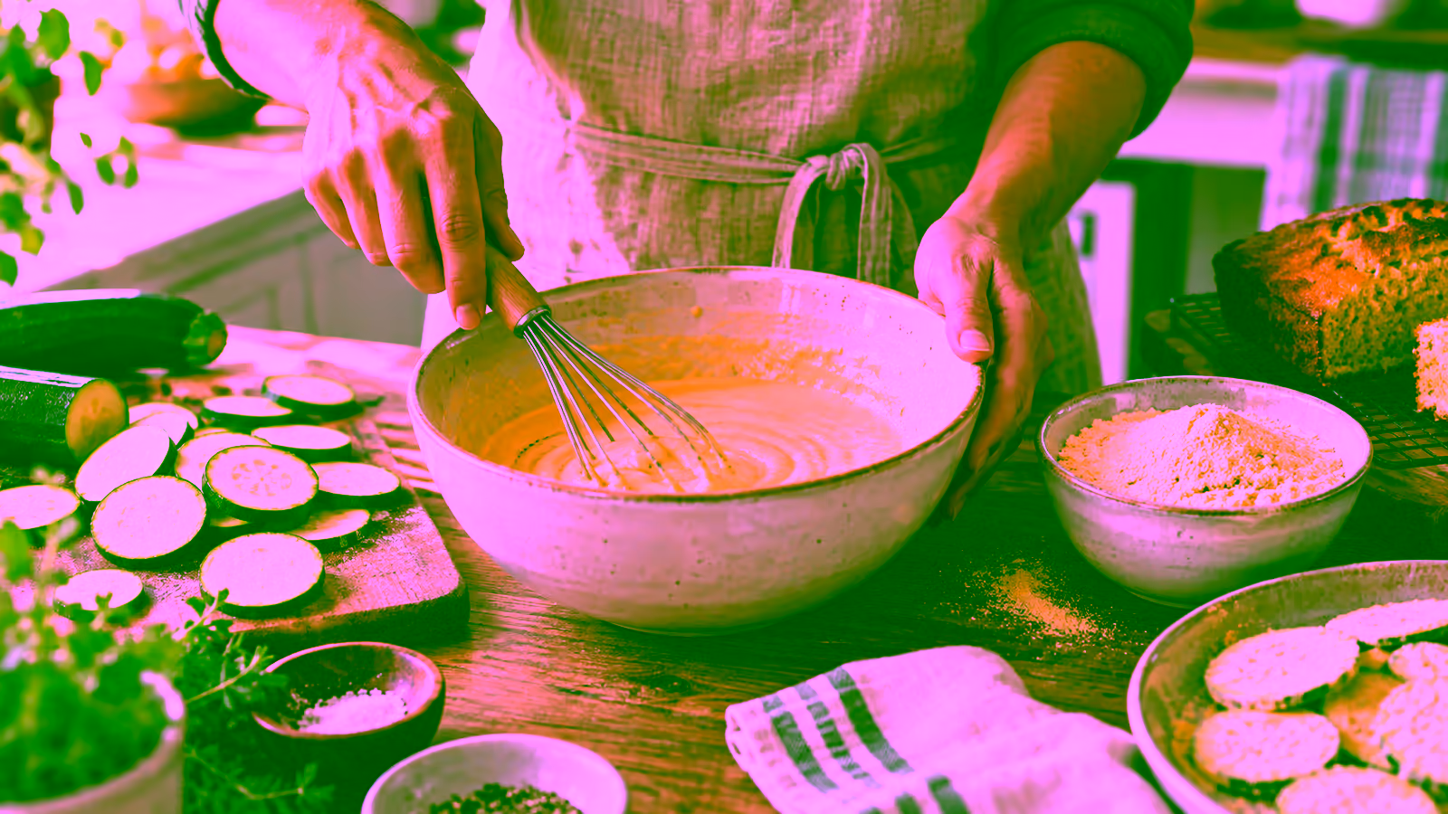A home cook whisking fine corn flour into a savory batter beside cornbread and vegetables