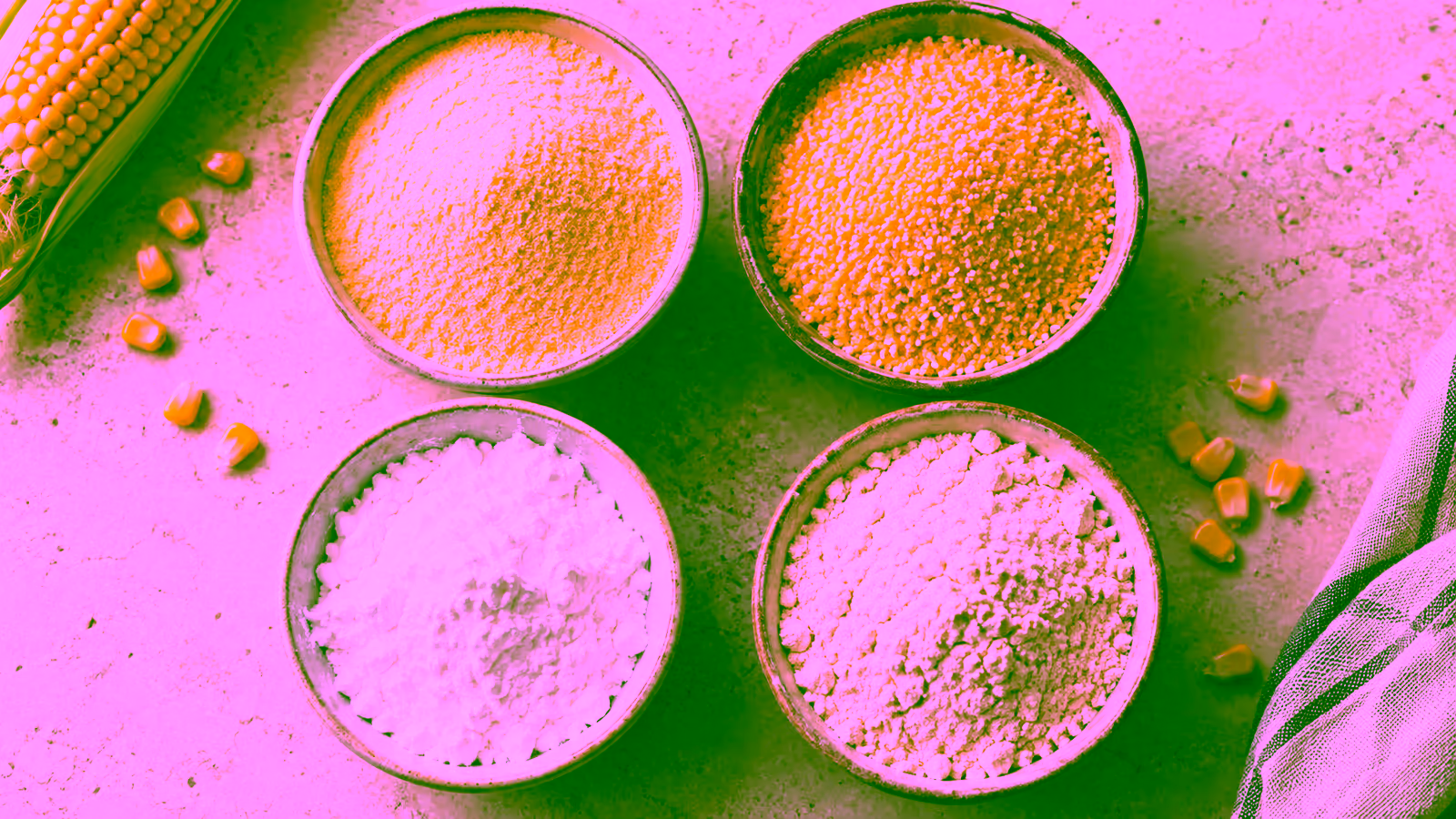Bowls of fine yellow corn flour, coarse cornmeal, white cornstarch, and pale masa harina viewed from above