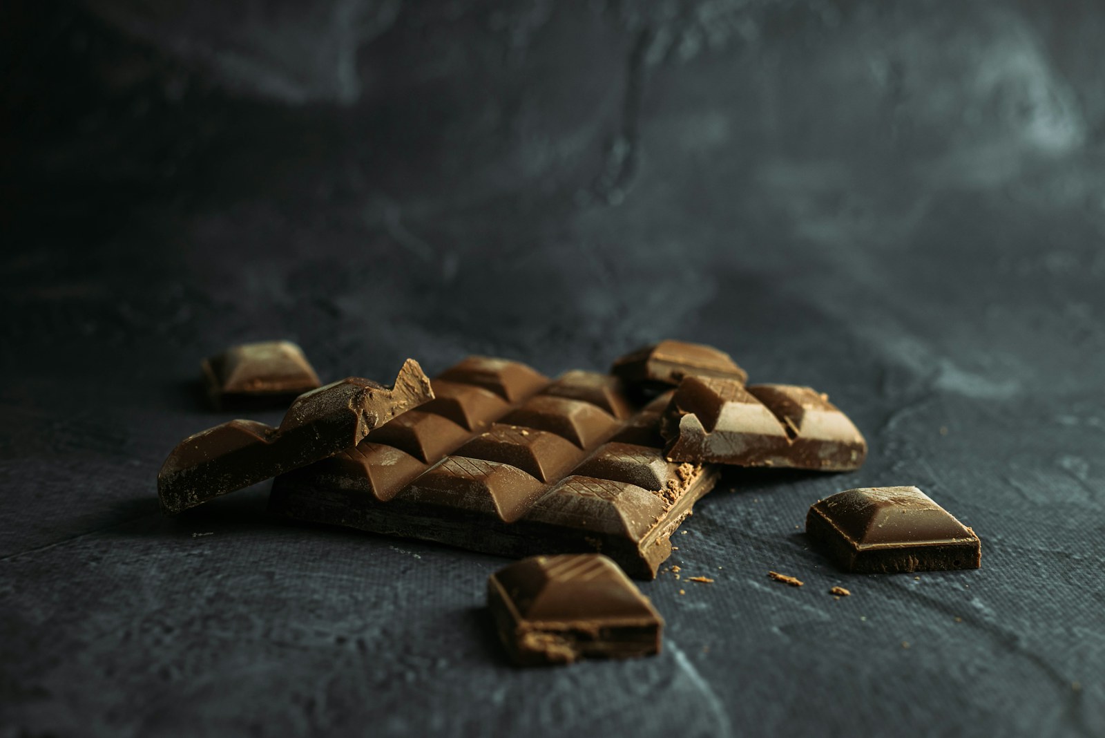 Dark chocolate pieces arranged on a surface