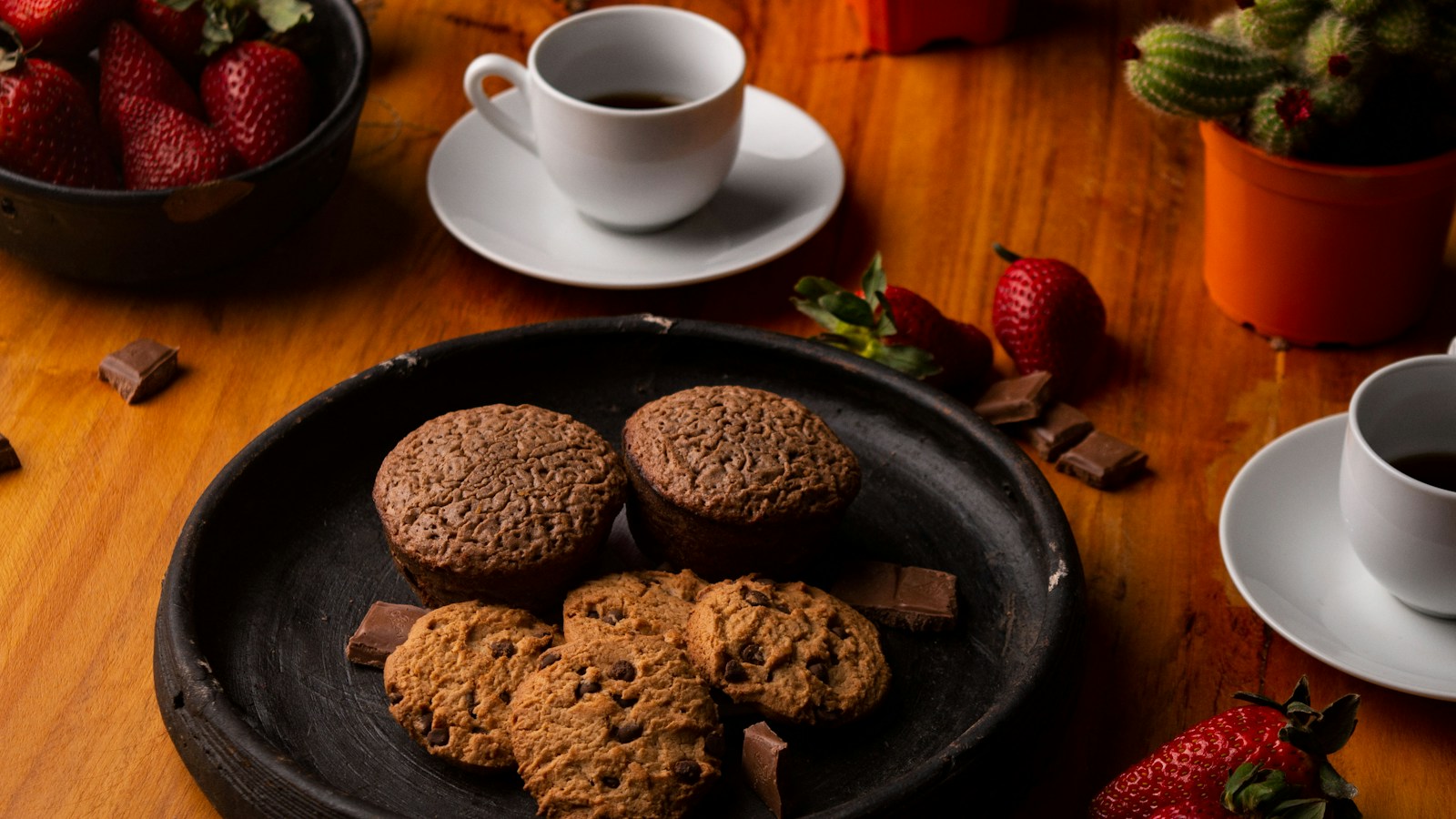 Cookies on a plate beside a cup