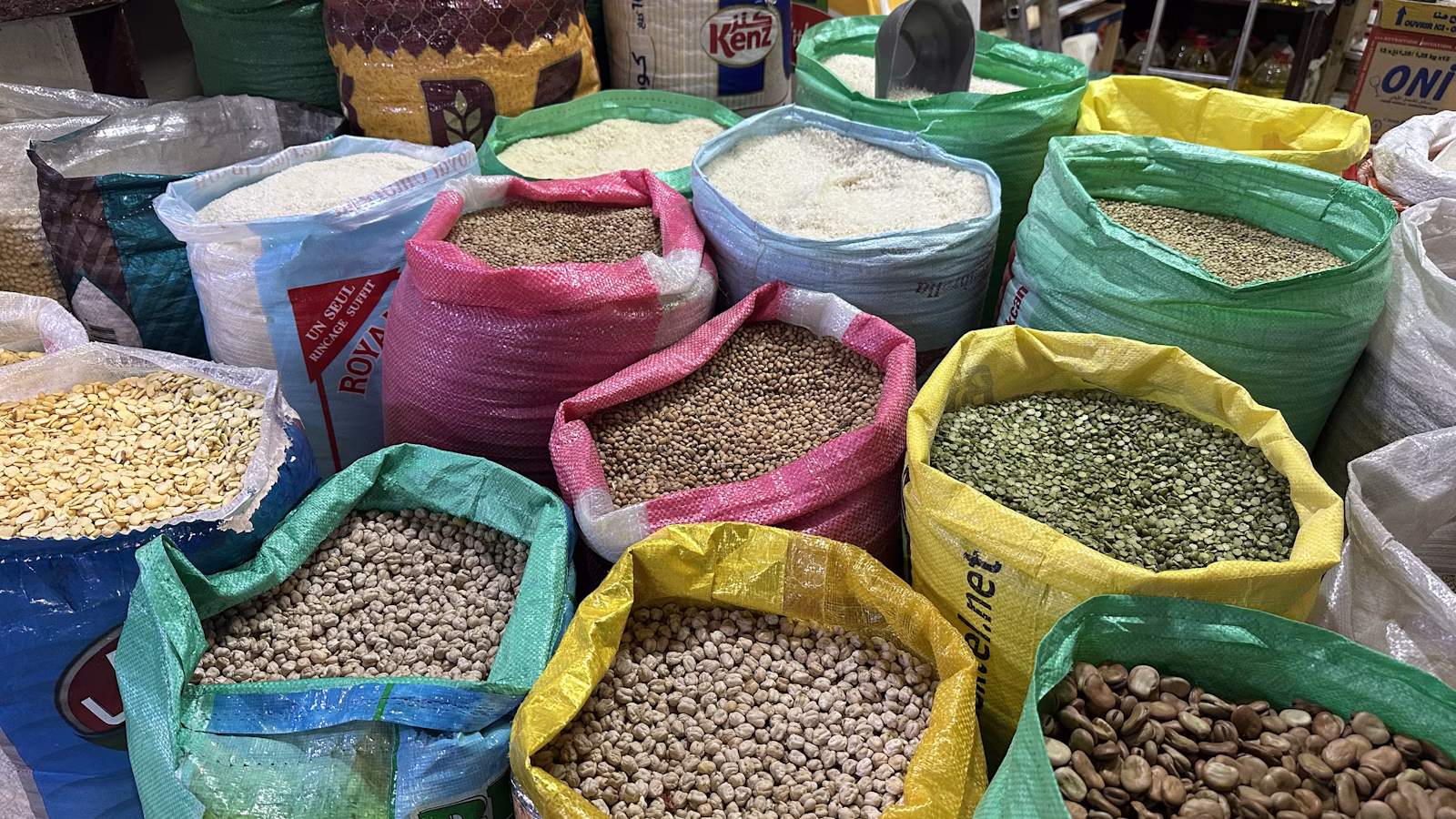 Colorful dried legumes displayed in market sacks