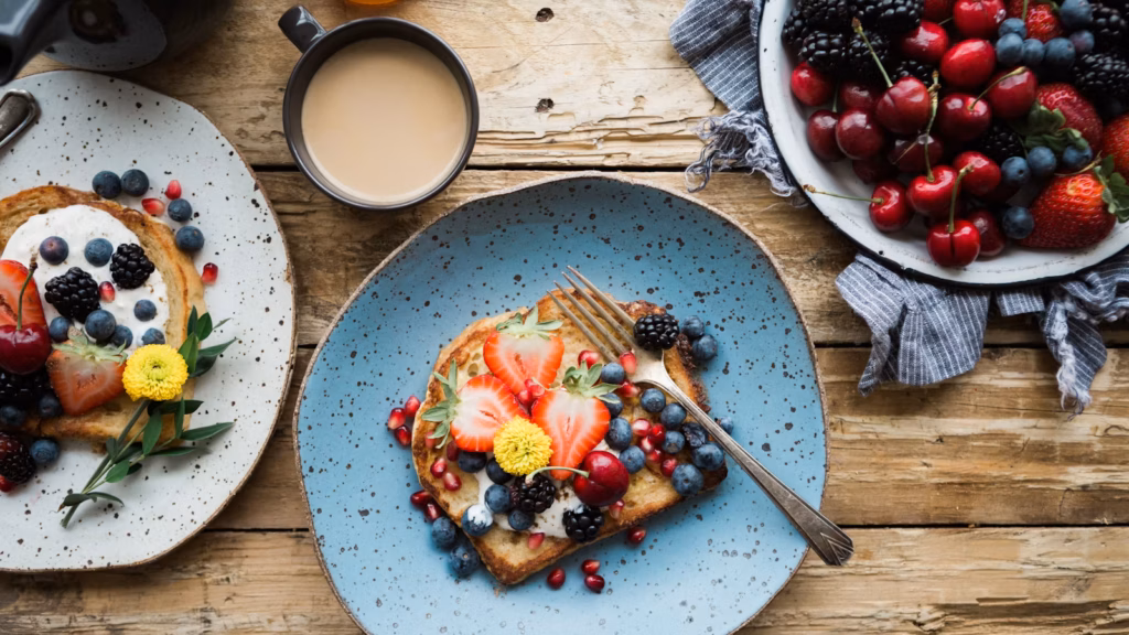 Golden French toast topped with berries on a breakfast table