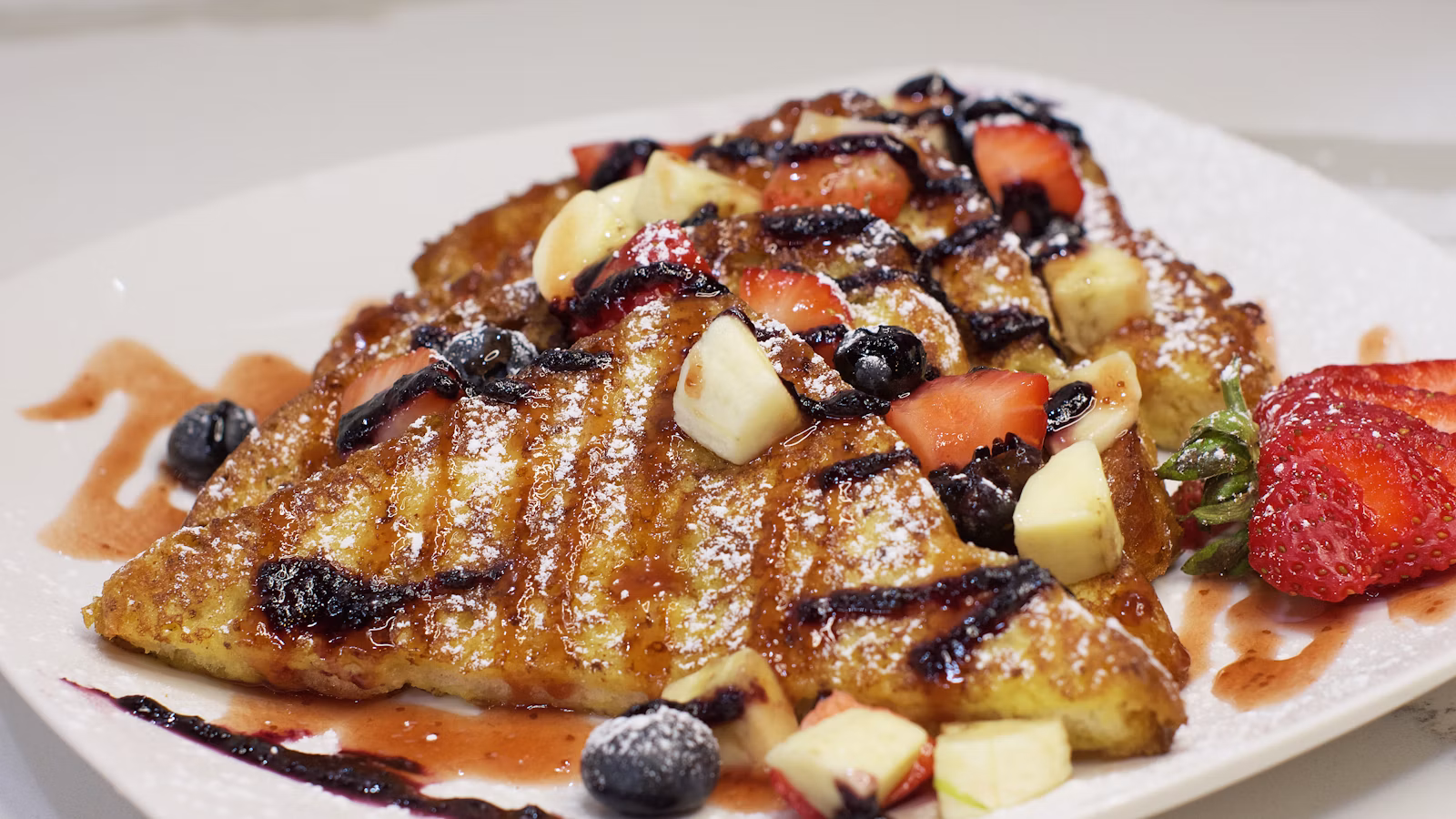 French toast served with fresh fruit and syrup