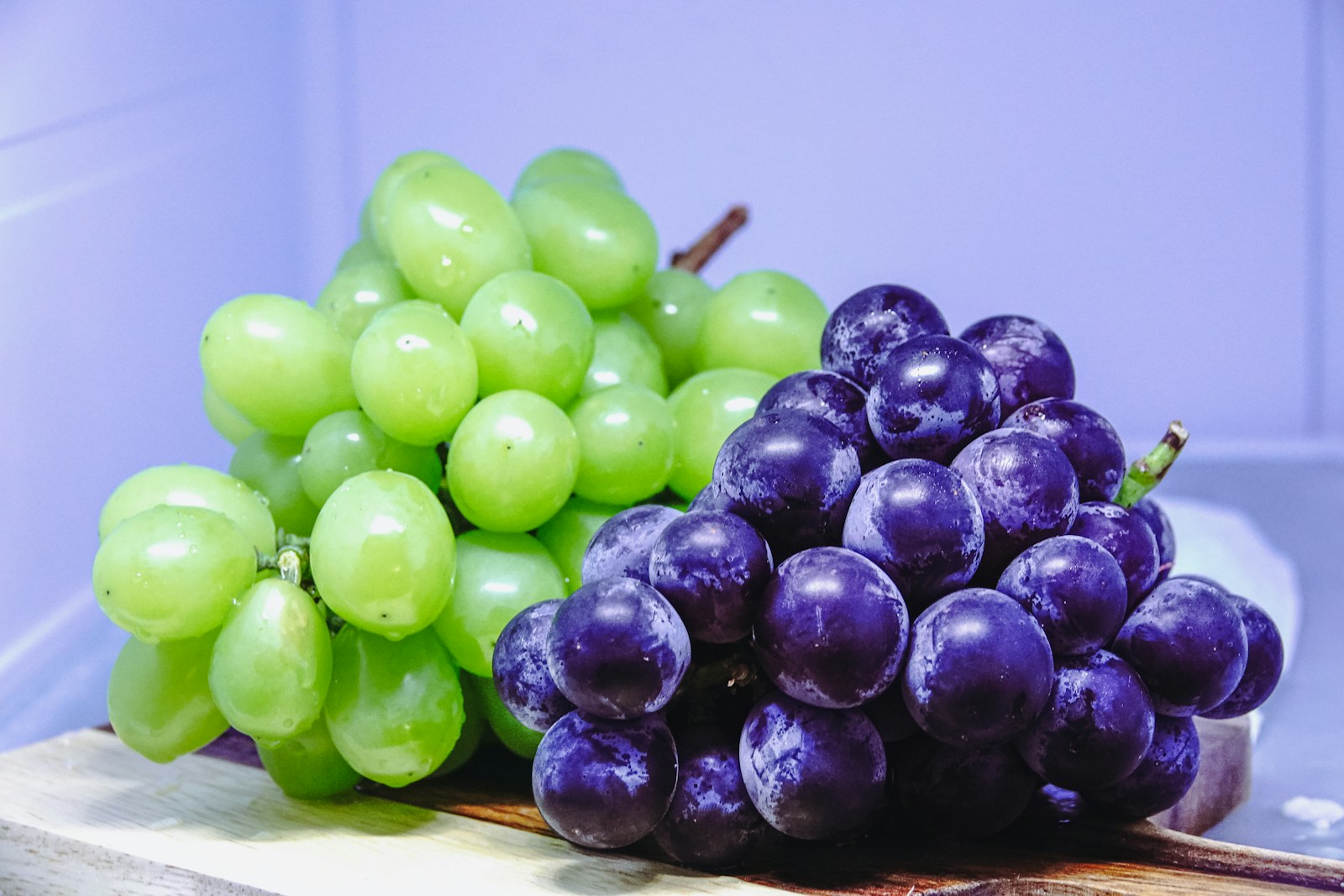 Bunches of fresh grapes on a cutting board