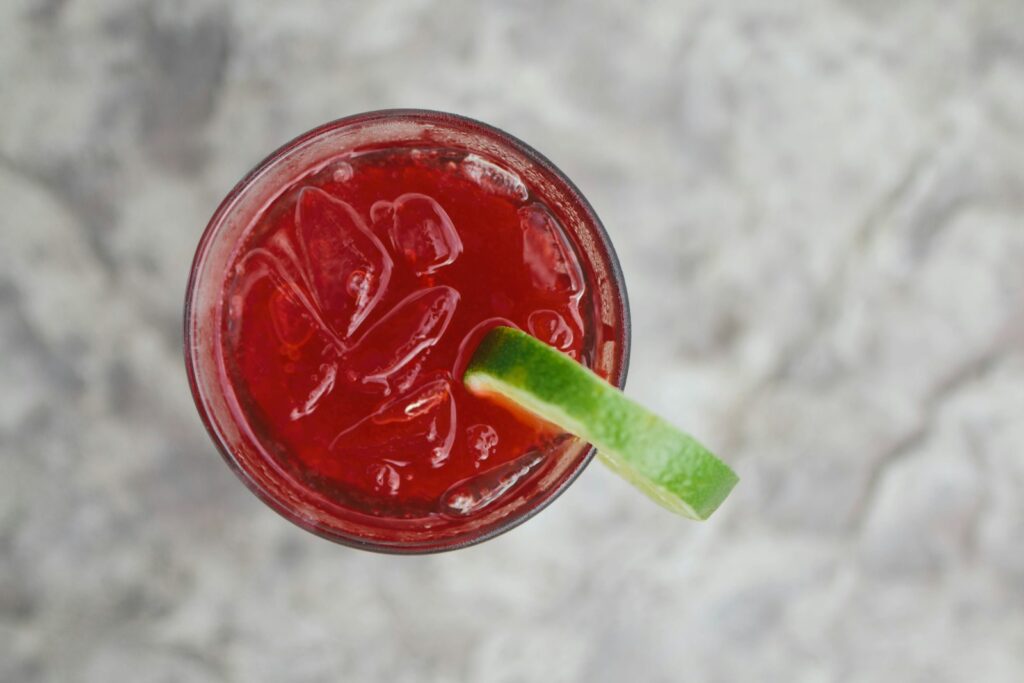 Clear glass filled with dark red fruit juice