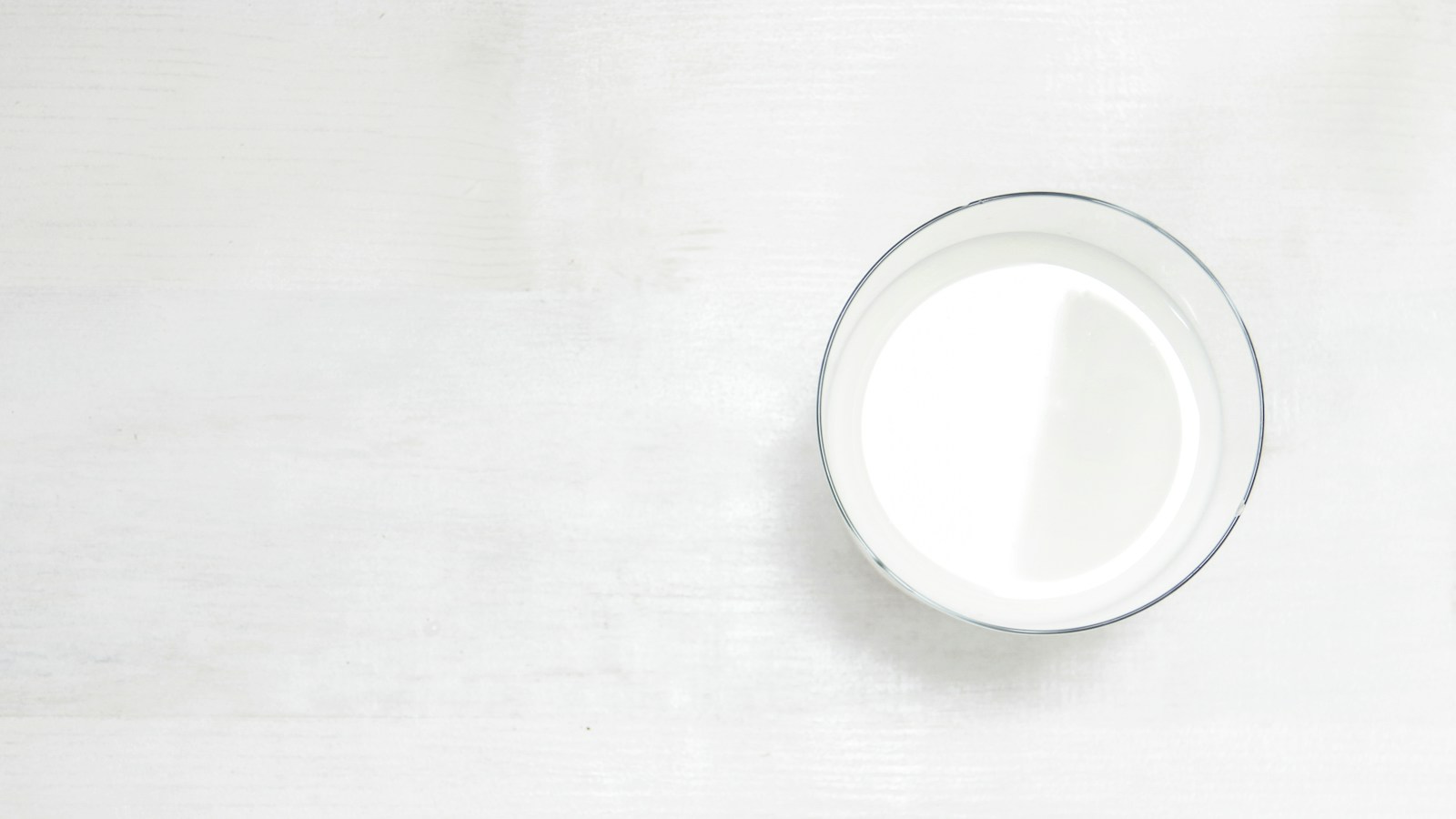 Glass of milk on a white table
