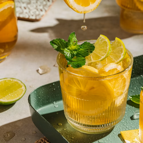 Homemade iced tea with lemon, lime, mint, and honey