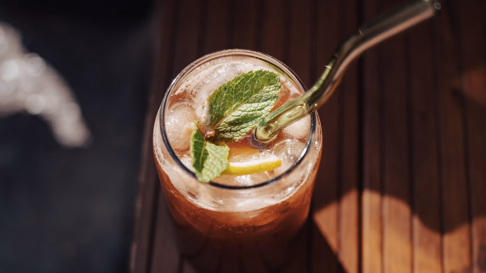 Glass of iced tea with mint and lemon garnish