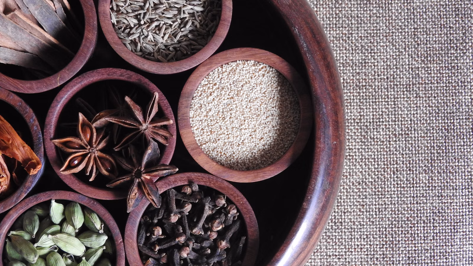 An open Indian spice box filled with ground spices