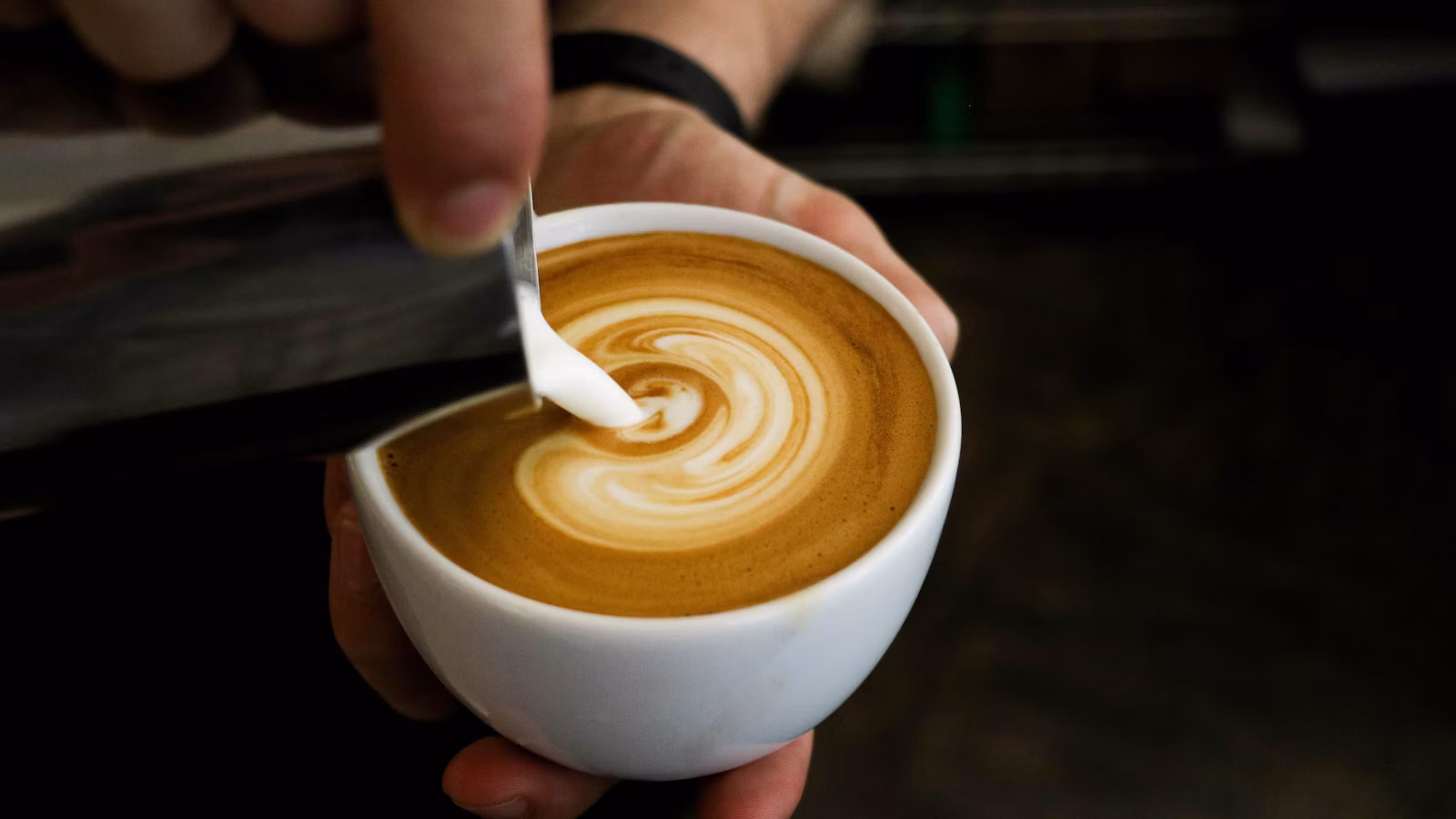 Steamed milk being poured into espresso for a latte