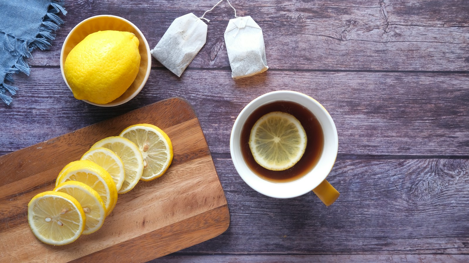 Cup of tea beside a slice of lemon