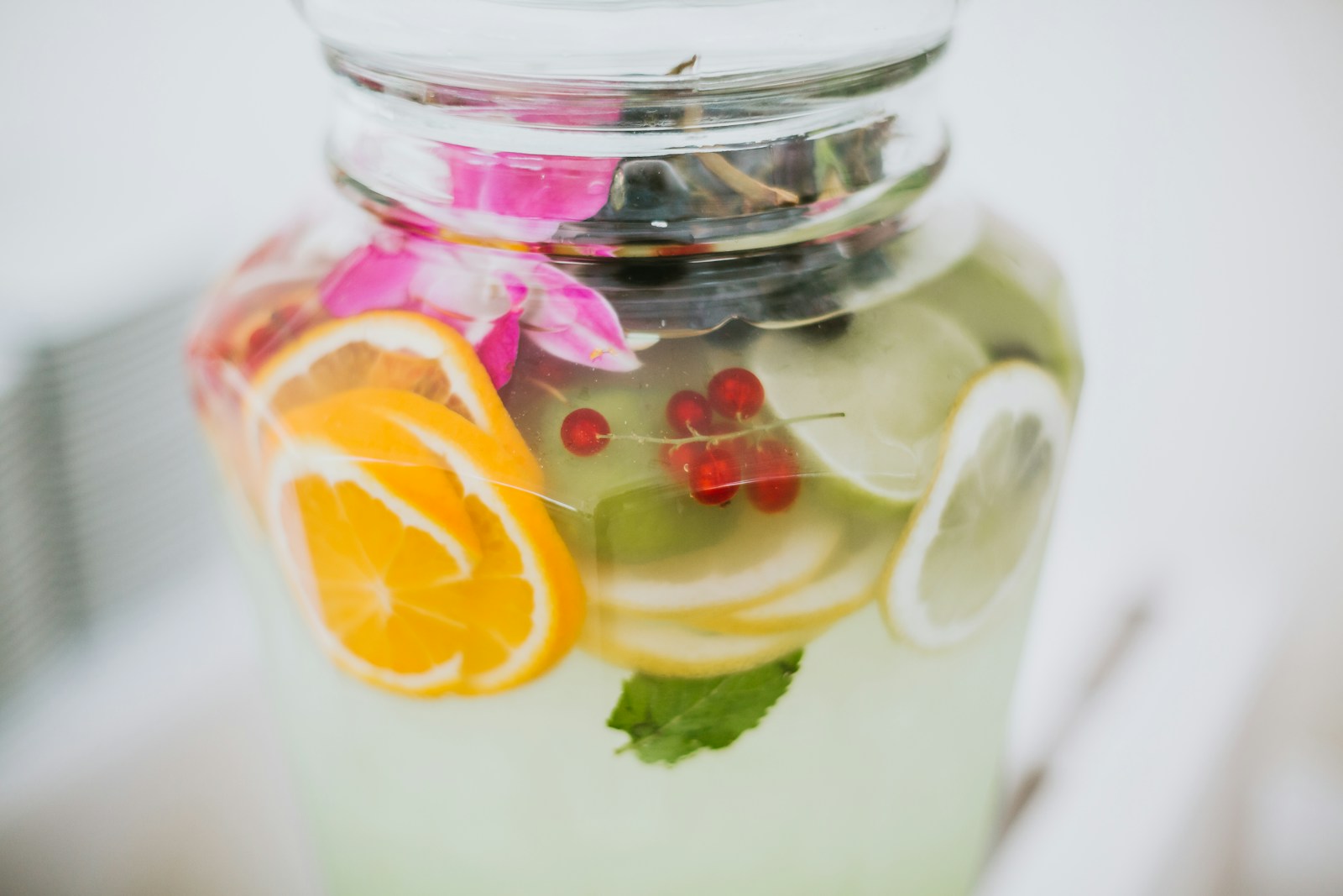 Clear water with lemon served in a glass jar