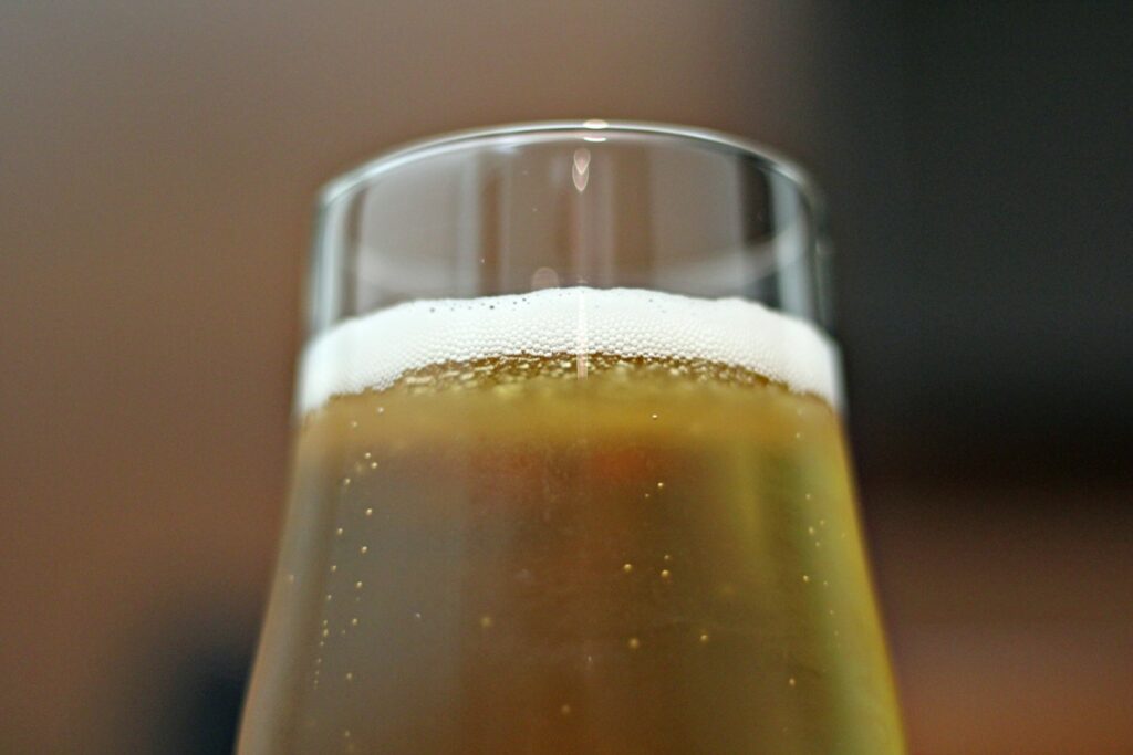 Pale beer in a clear glass on a table