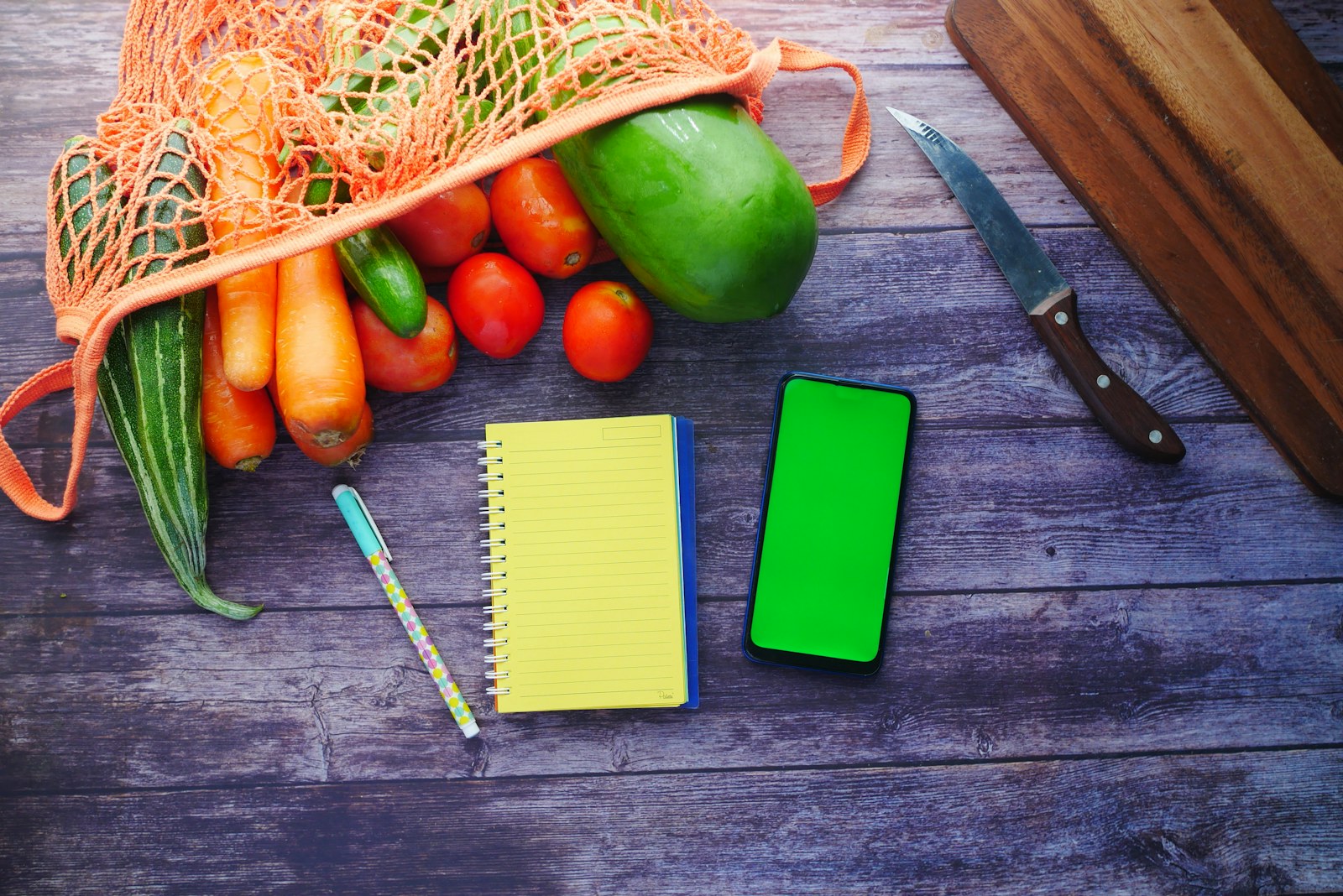 Meal-planning notebook beside fresh produce