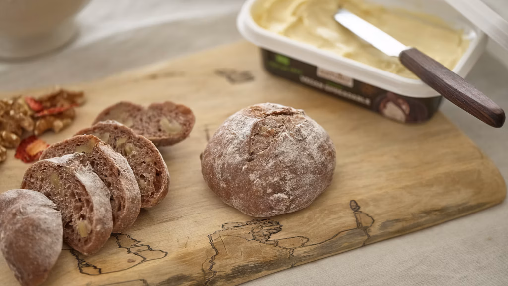 Rustic cutting board with a spicy Italian-style spread and bread