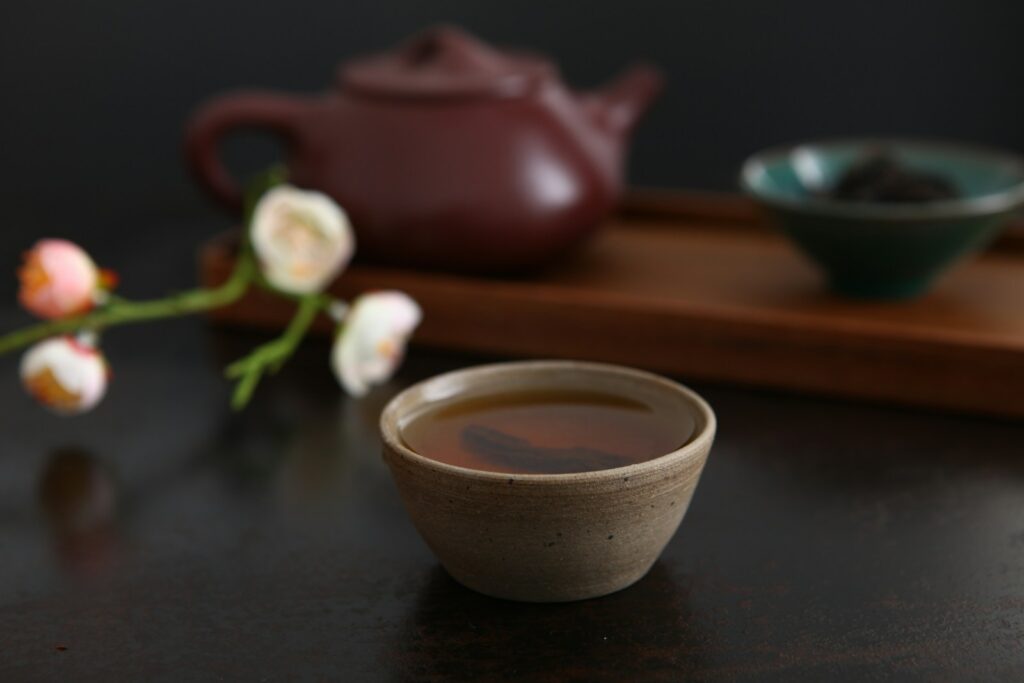 Oolong tea served beside loose tea leaves
