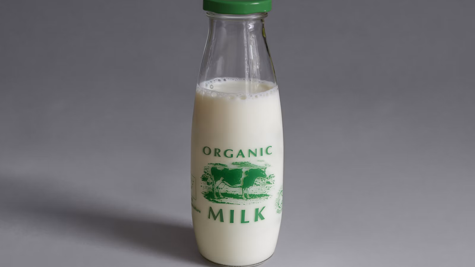 A glass bottle of milk on a light kitchen surface