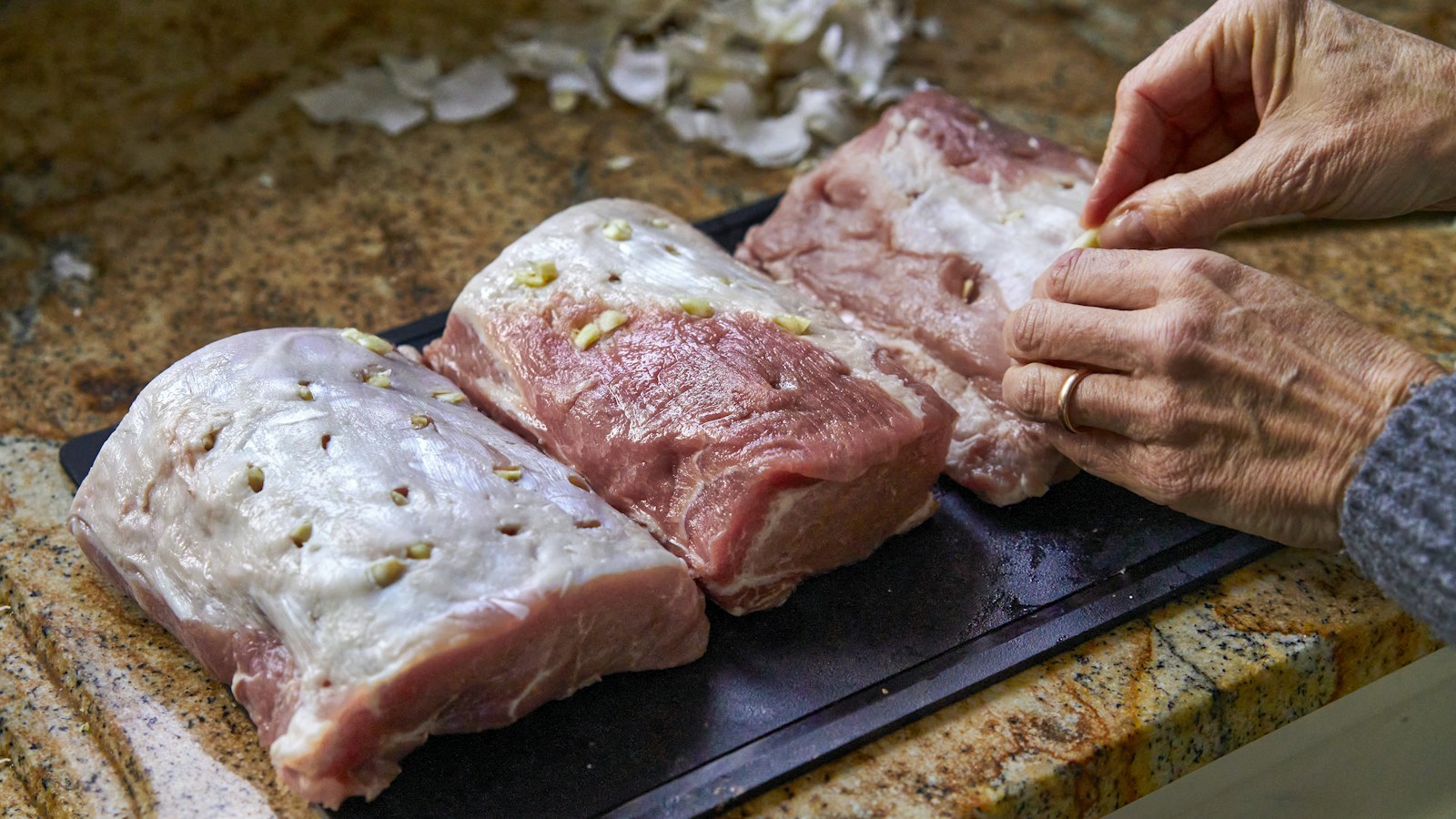 Raw pork with garlic on a kitchen board