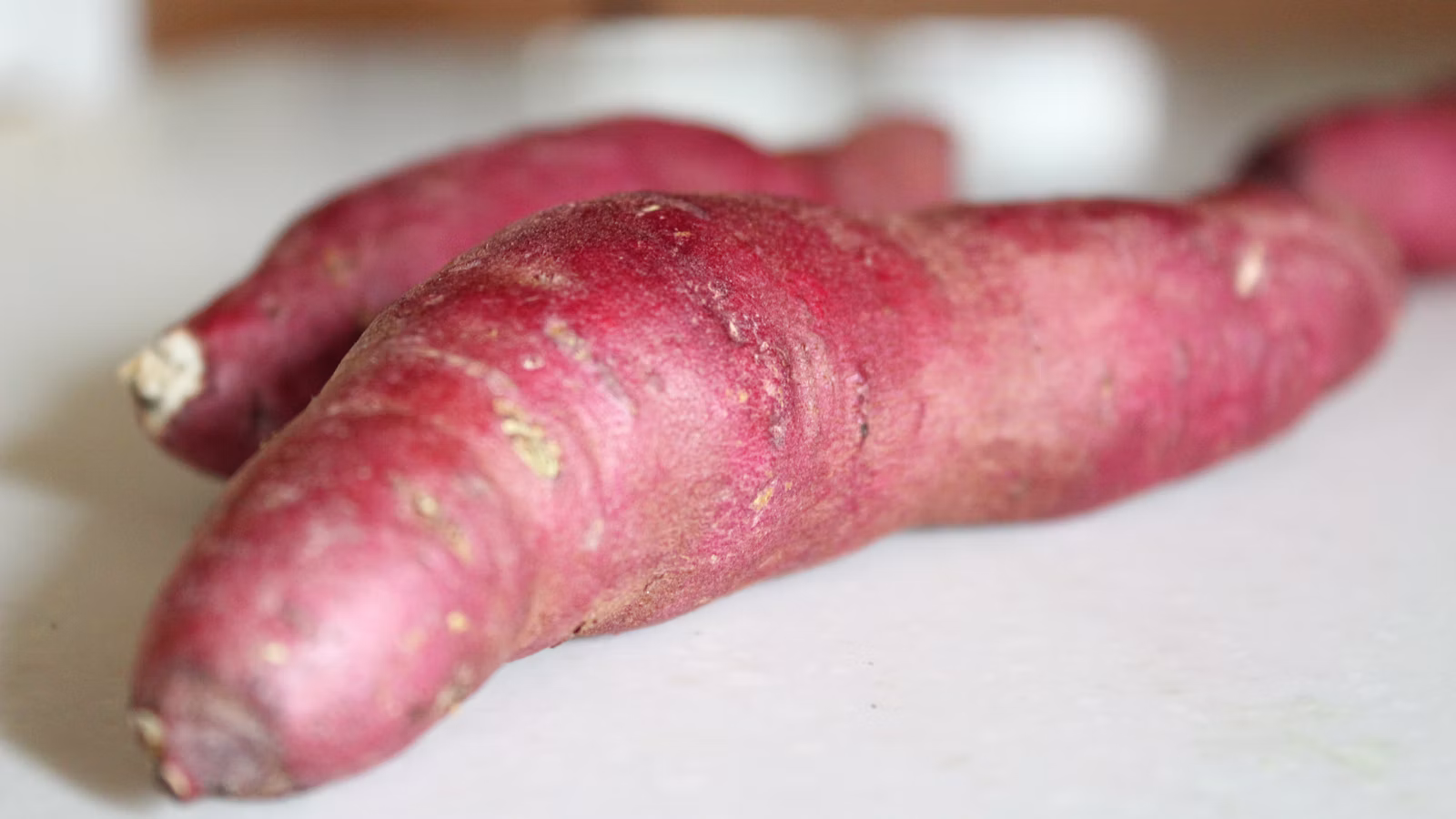 A purple-fleshed root vegetable cut open on a table
