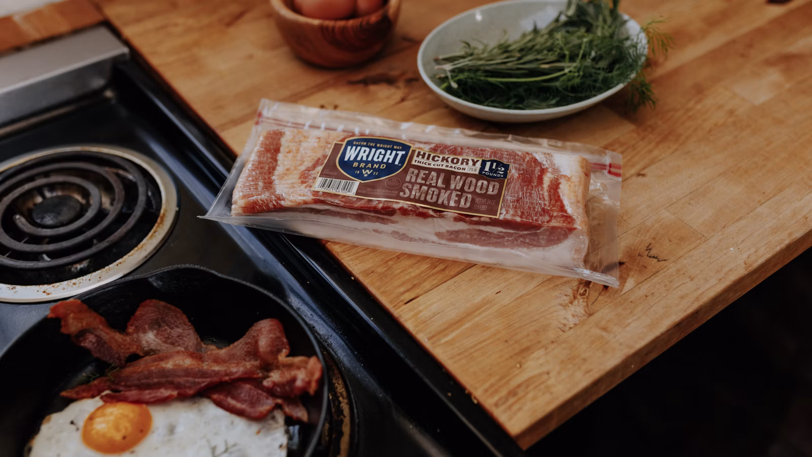 Raw thick-cut bacon strips on a wooden board