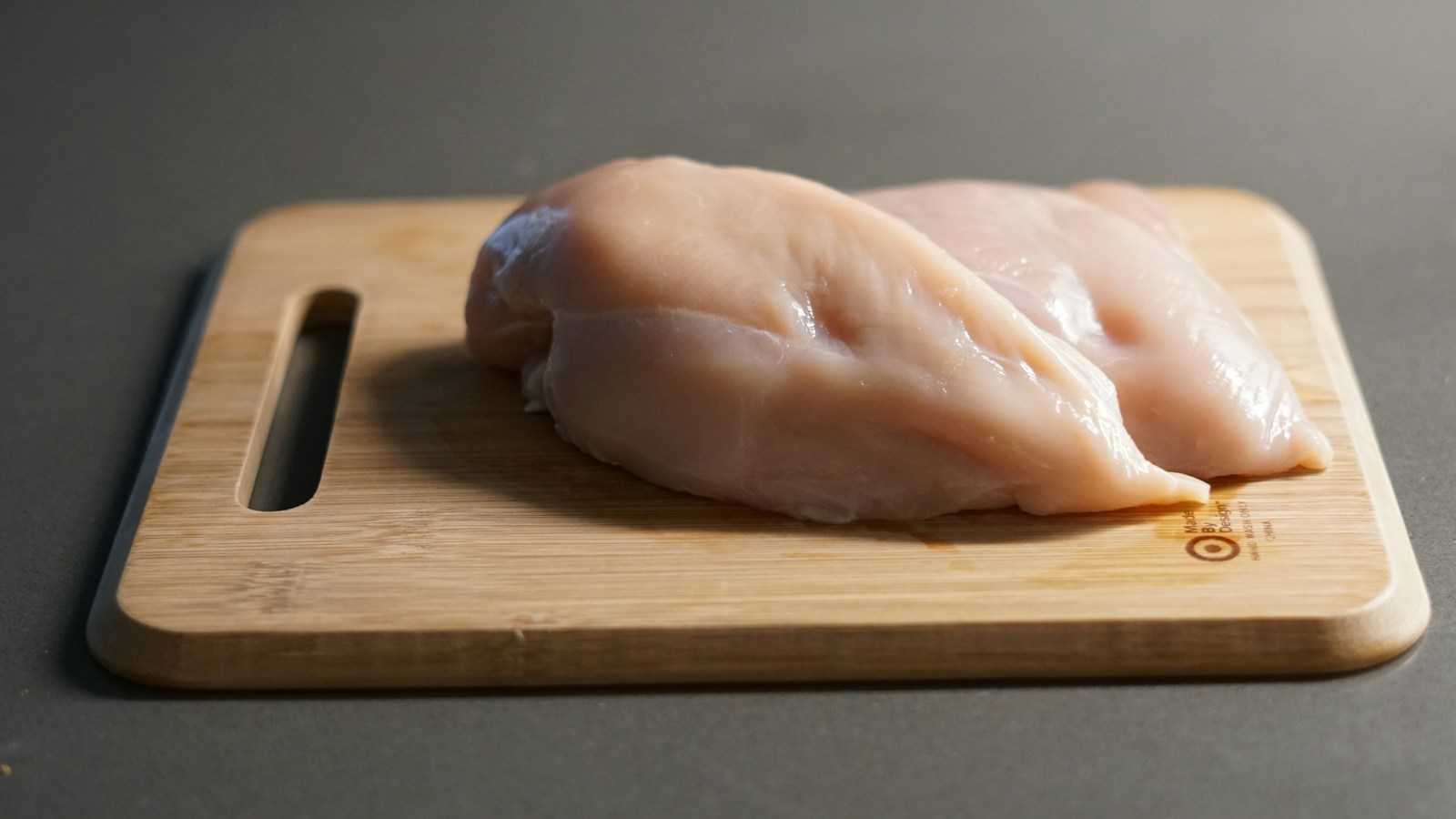 Raw chicken on a cutting board, a cross contamination risk