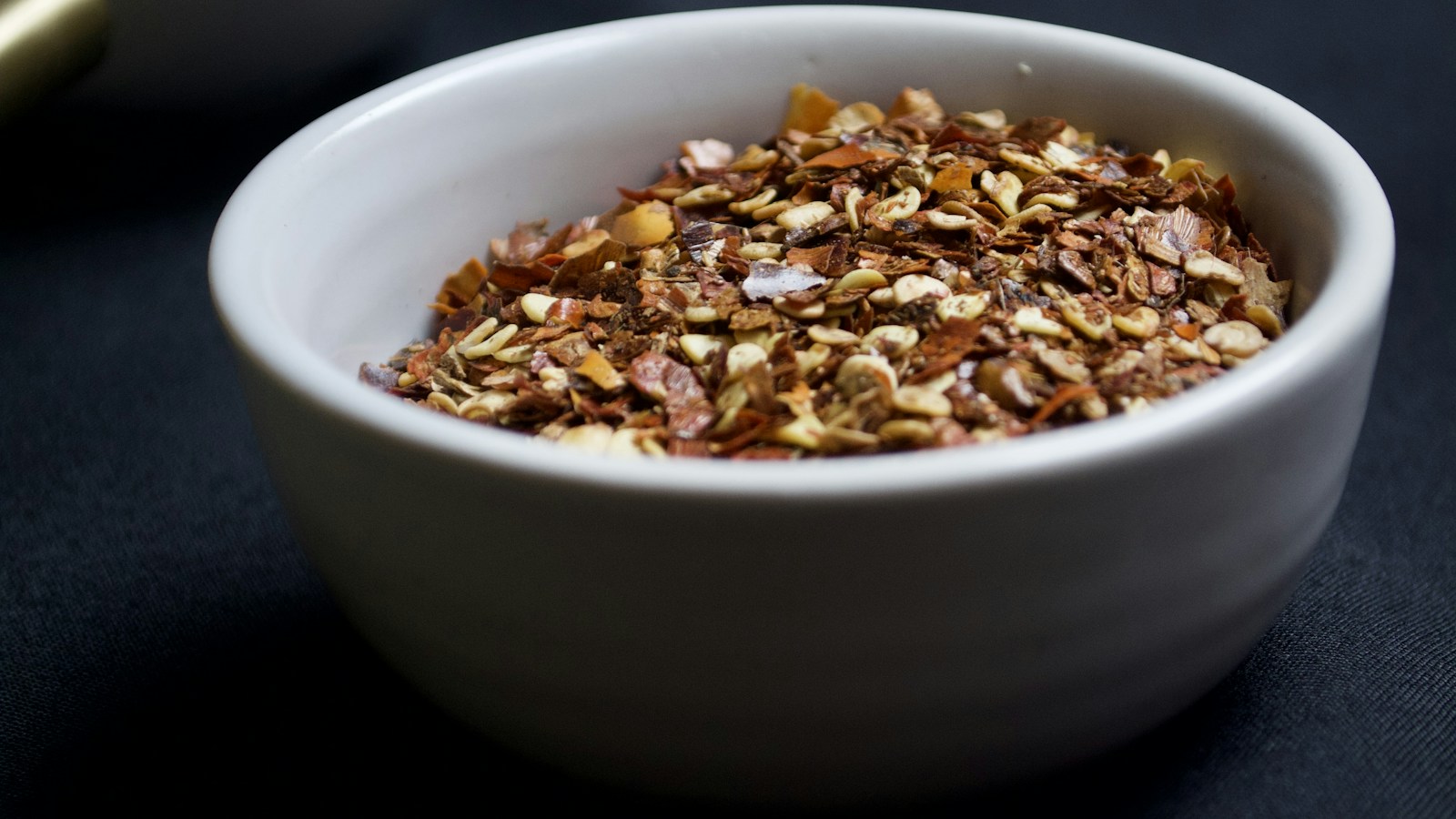 Red pepper flakes in a white ceramic bowl