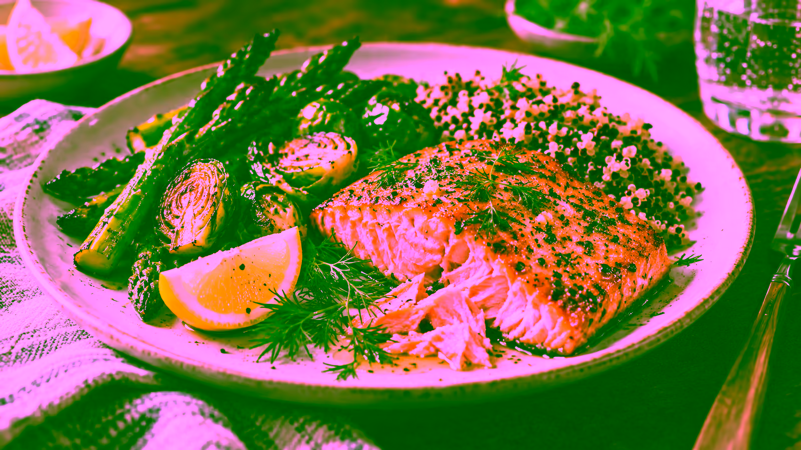 Safely cooked salmon served with roasted vegetables, lemon, herbs, and whole grains