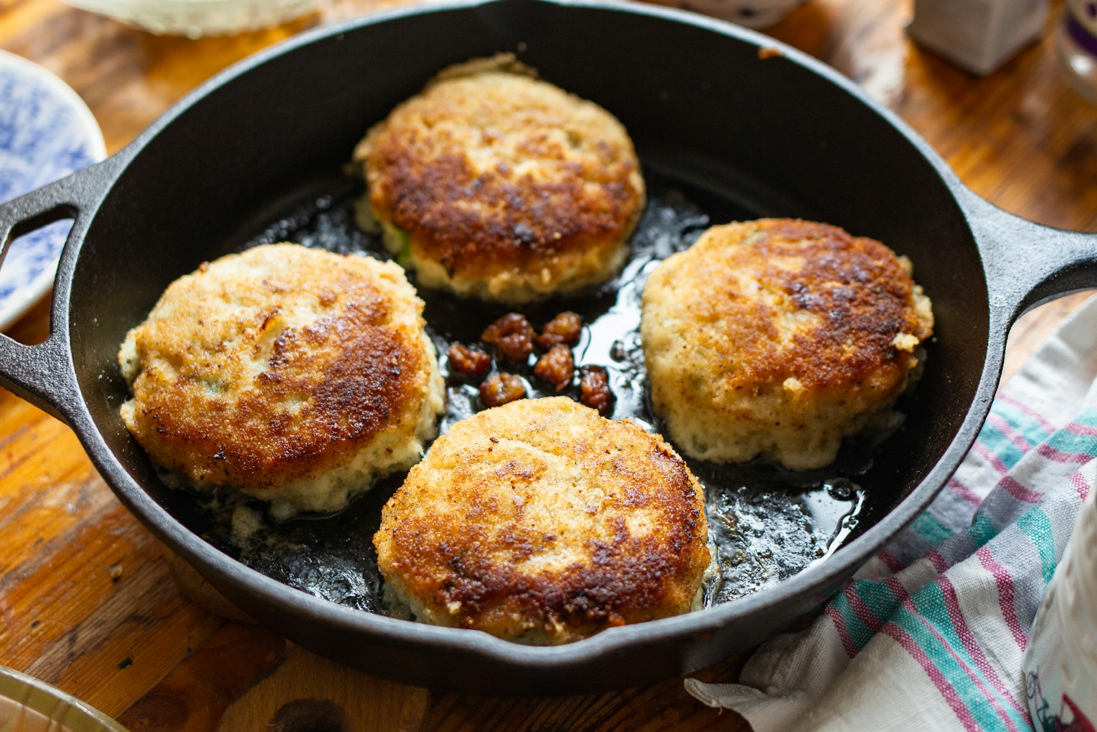Golden salmon patties cooked in a skillet