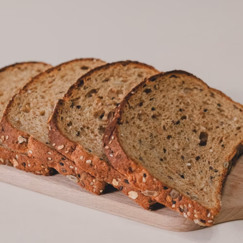 Sliced homemade bread arranged on a white table