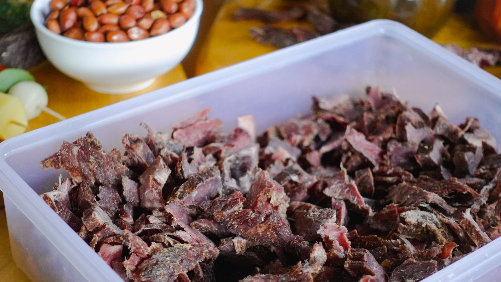 Sliced biltong served with peanuts