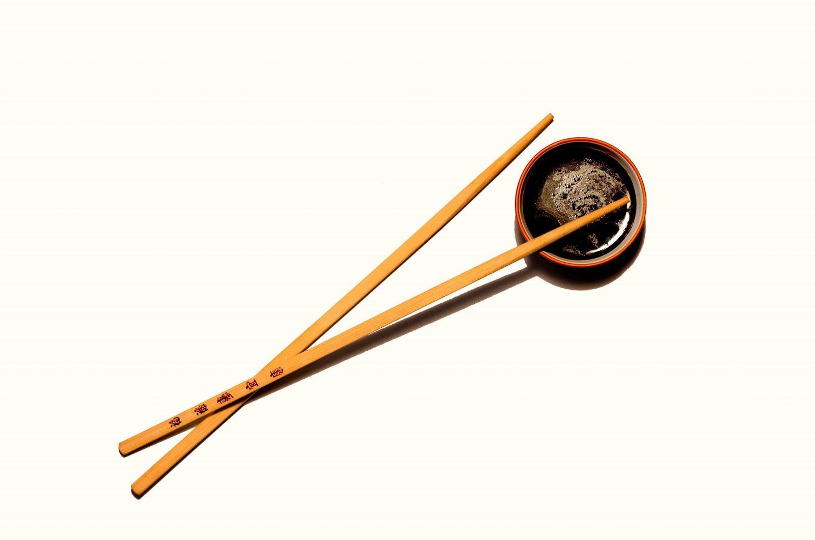 Small dish of soy sauce beside chopsticks