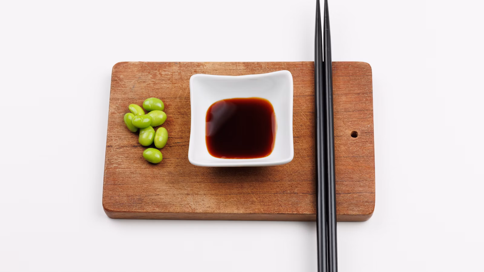 Small bowl of dark savory sauce with chopsticks