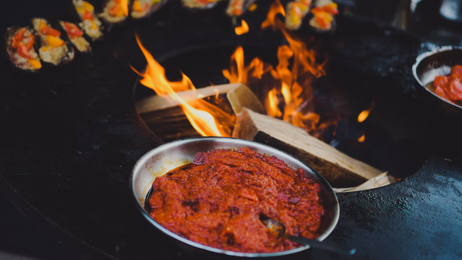 Spicy red sauce cooking in a pan over high heat