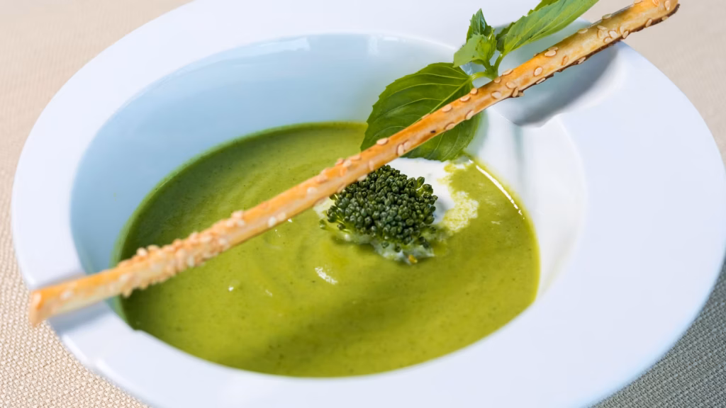 Thick green split pea soup served in a white bowl