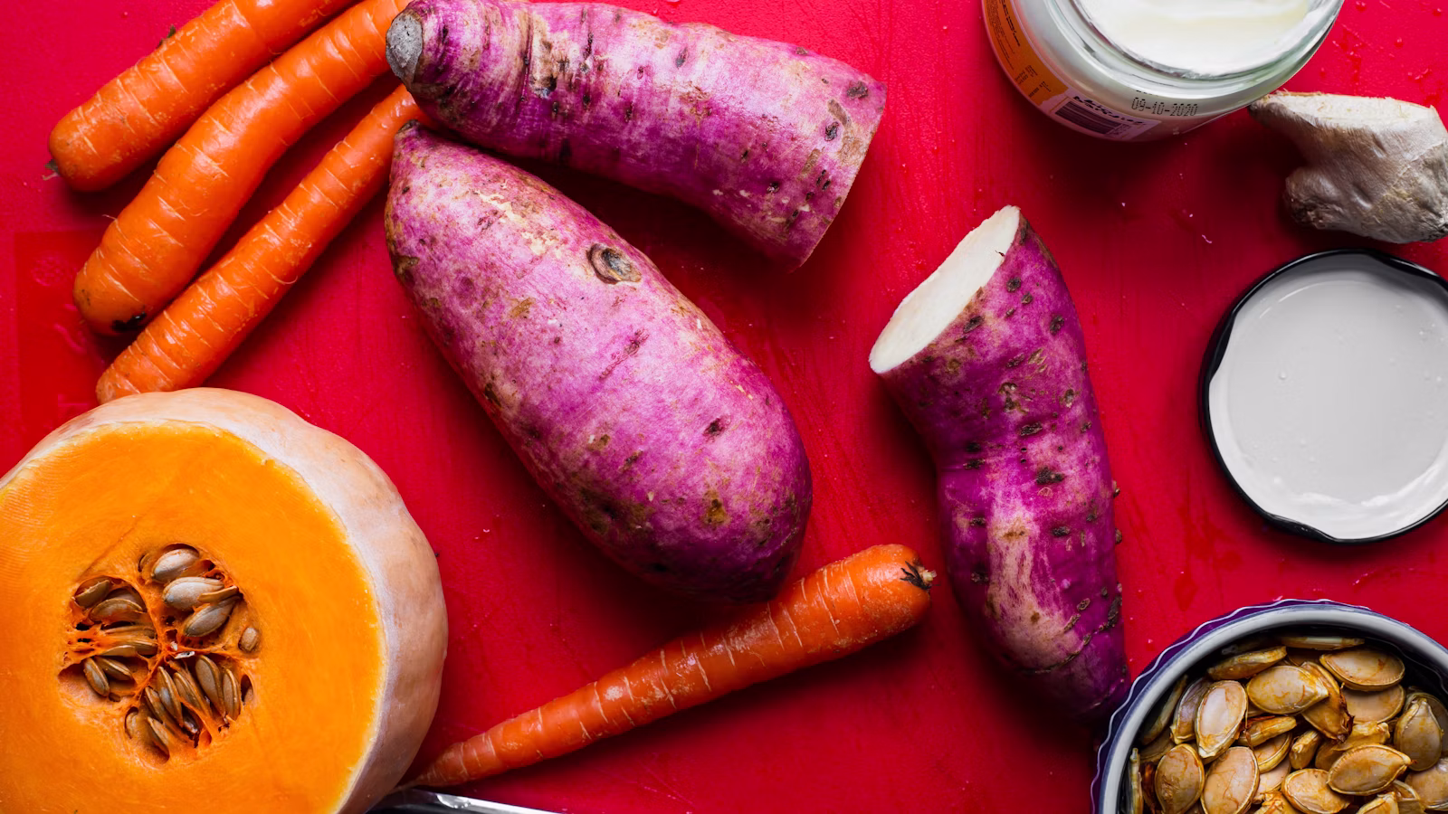 Sweet potatoes arranged with colorful root vegetables
