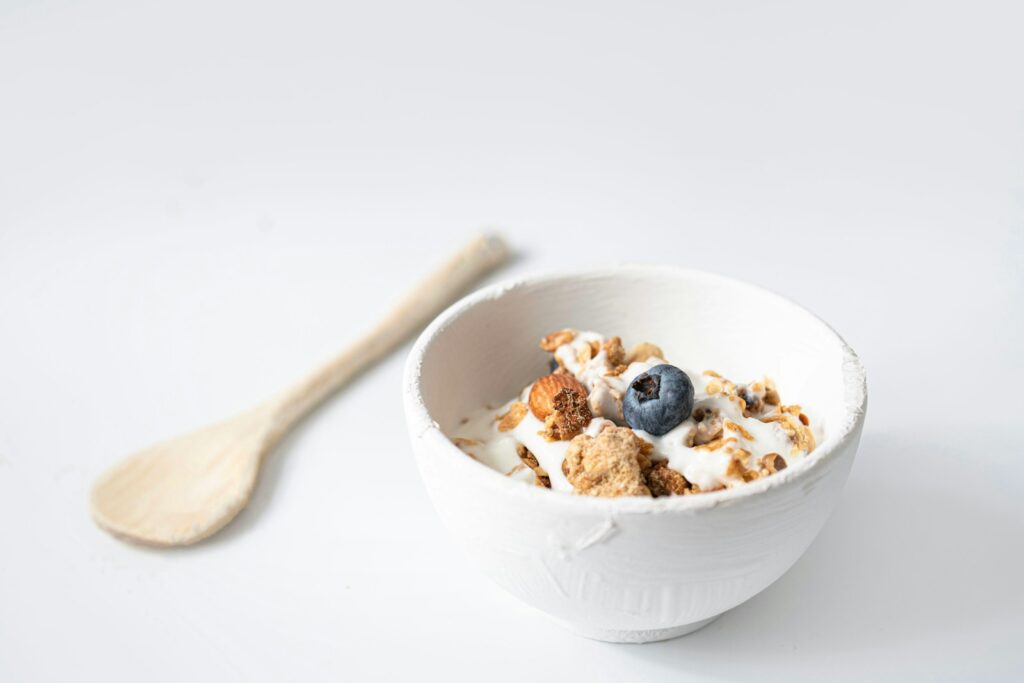 Creamy yogurt bowl topped with cereal and fruit