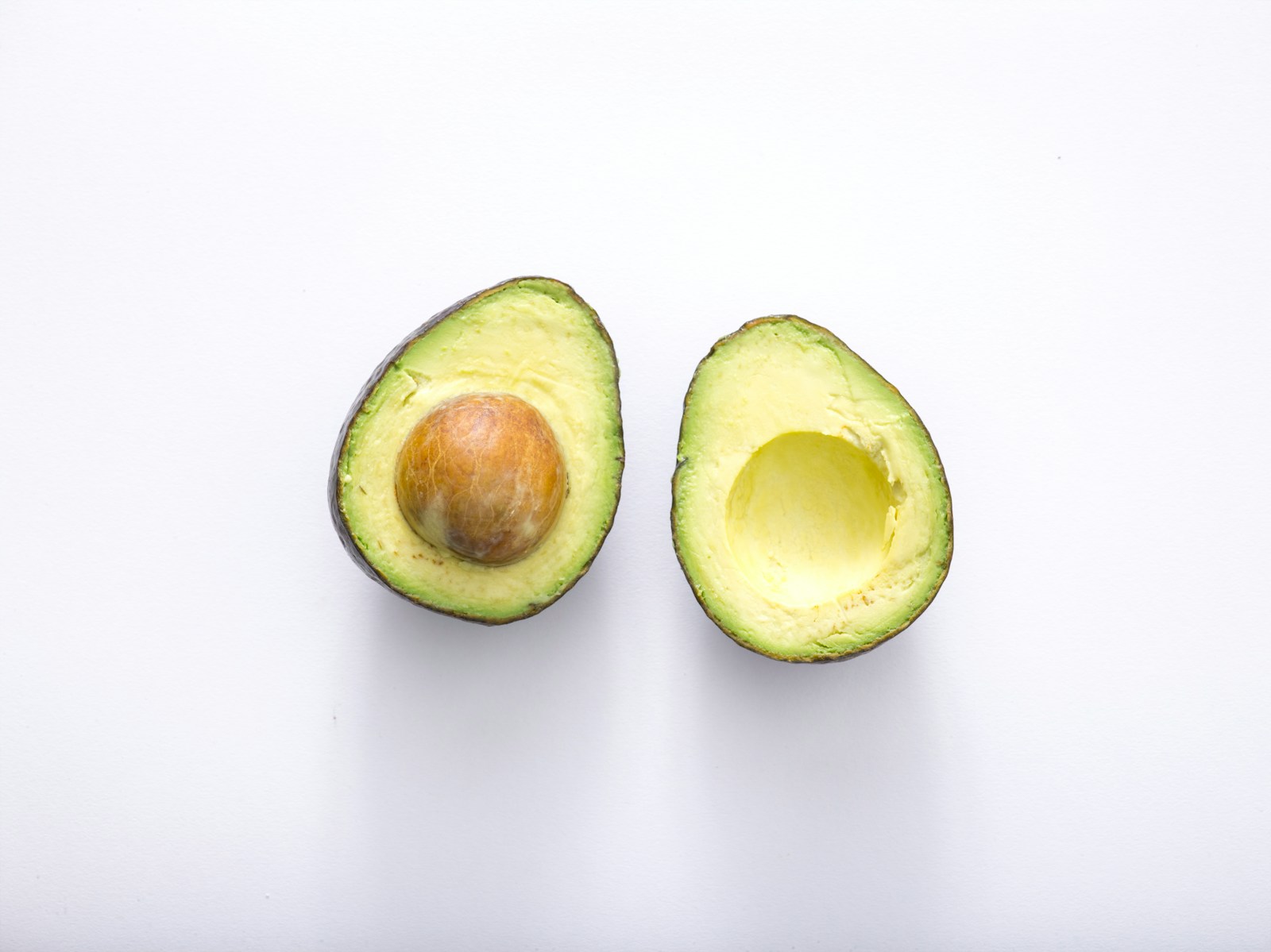Two avocado halves with the flesh exposed